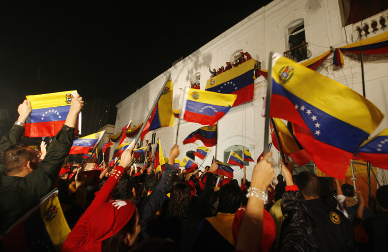 Image: Supporters of Venezuelan President Chavez celebrate in front of Miraflores Palace as Chavez gives a speech after official election results gave him a victory by a wide margin in Caracas